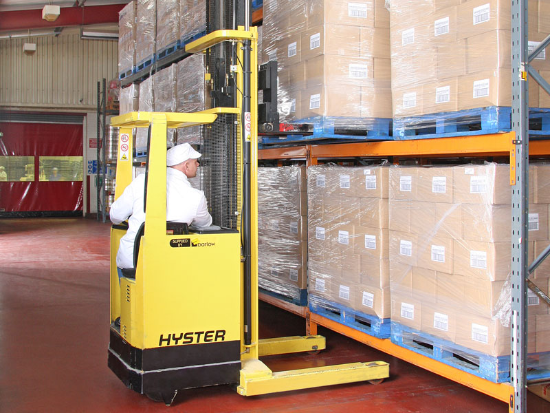 The corrugated outers containing the display boxes are palletised. The pallets are then put onto the warehouse racking by using a forklift truck.